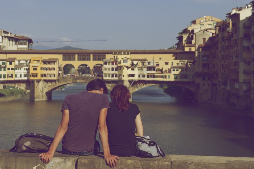 A Man and a Woman Looking at a Bridge Over a River