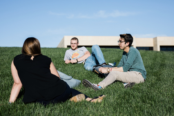 3 Missionaries Sitting in the Grass at the University of Mary