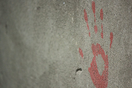 A Painted Red Hand on a Cement Wall