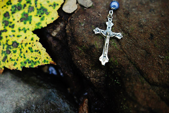 The Crucifix From a Rosary on the Ground