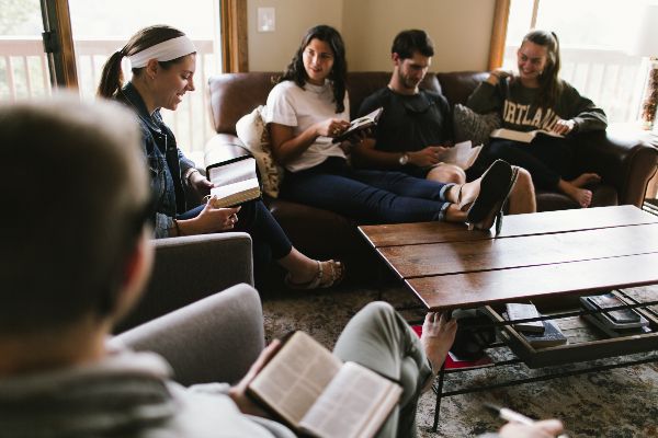Five Missionaries Sitting and Reading the Bible