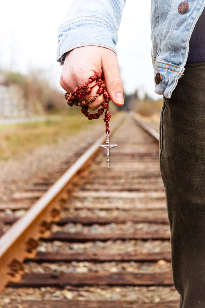 Holding a Rosary on the Train Tracks - Full