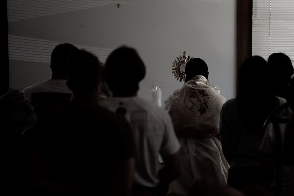 A Priest and Students in Adoration at Napa