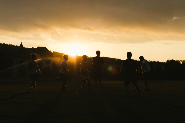 Men Playing Soccer in a Field
