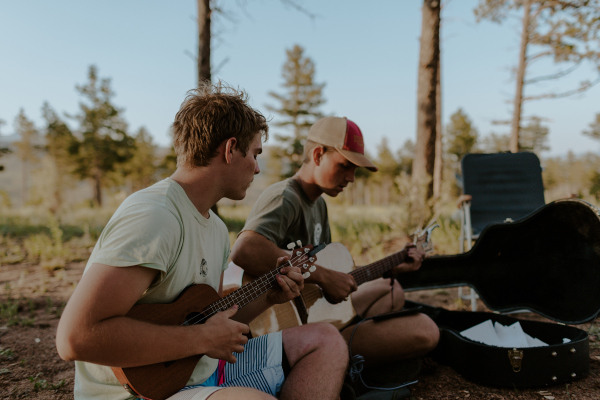 Two Male Students Playing the Guitar at Summer Projects