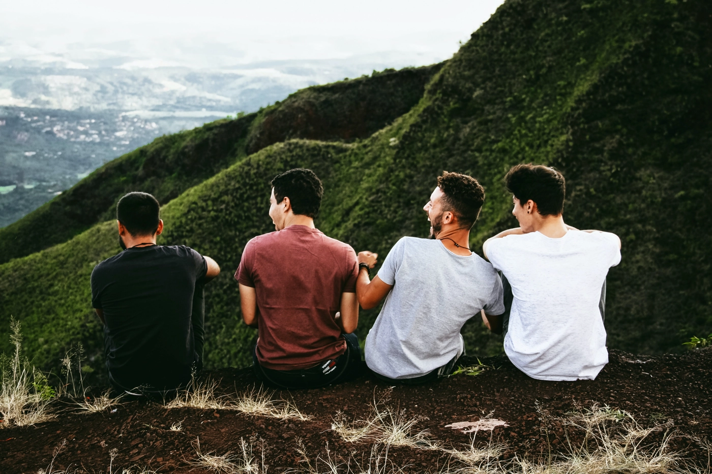 male friends laughing together on a mountain