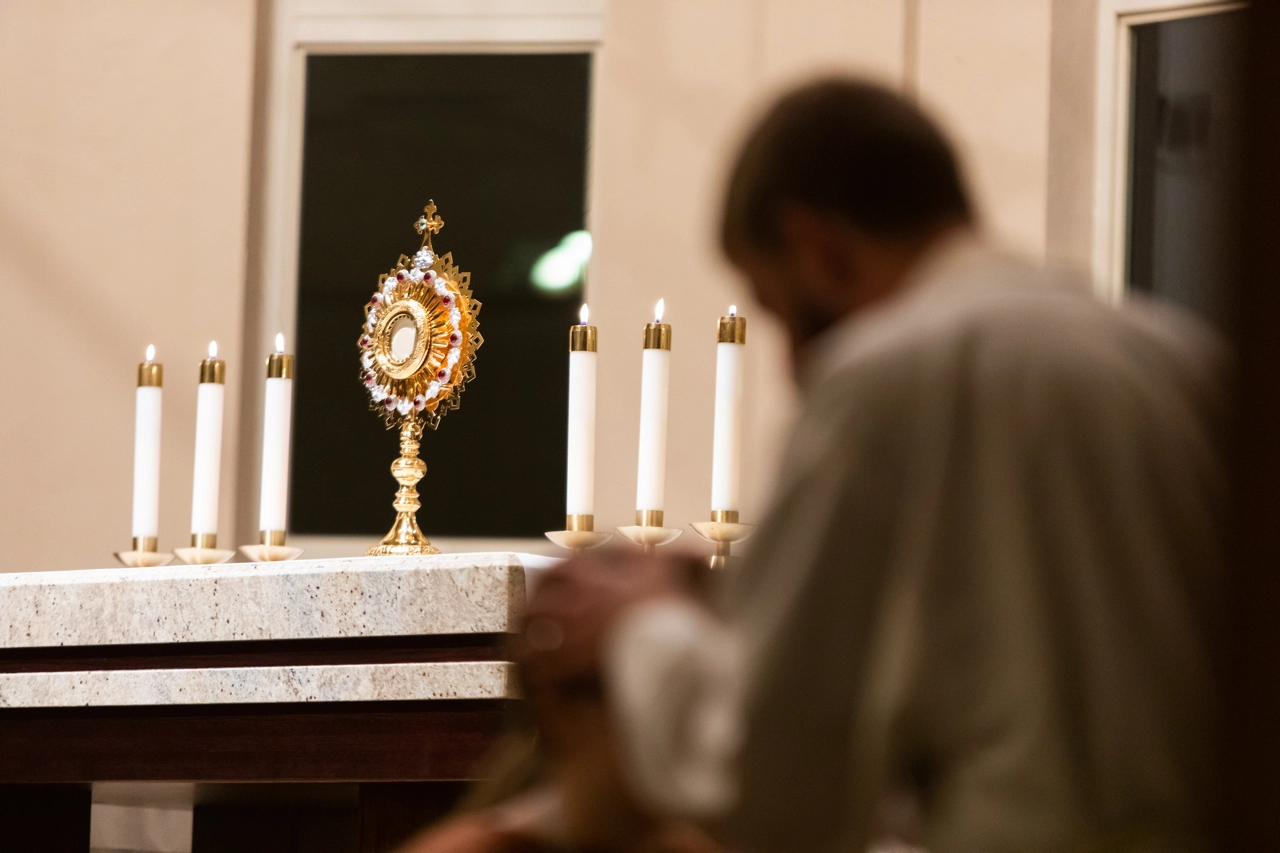 A Young Priest in Adoration